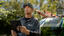 A1 technician with tablet outside with blurry van in background.