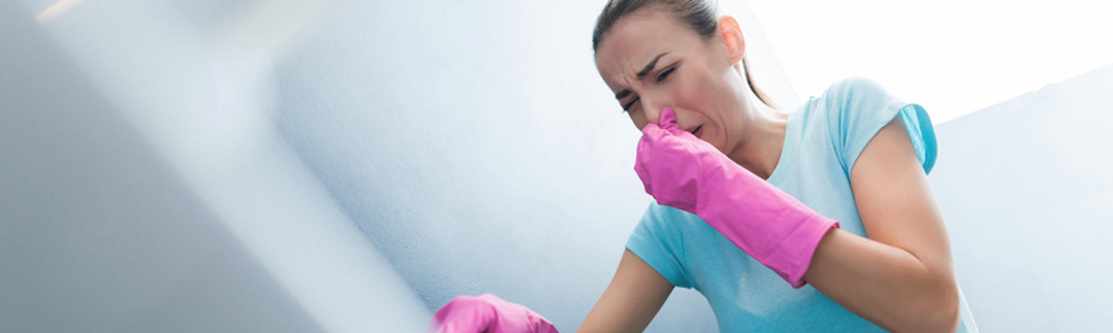 Woman with gloves plunging and holding noise.
