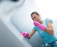 Woman with gloves plunging and holding noise.