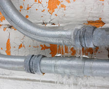 Frozen pipes with icicles.
