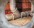Close-up of sewer pipes in the basement.