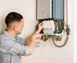 A1 Technician inspecting water heater.