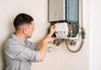 A1 Technician inspecting water heater.