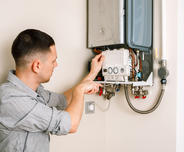 A1 Technician inspecting water heater.