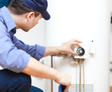 A1 technician checking water heater temperature.