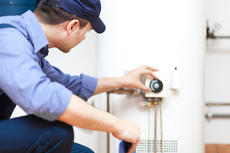 A1 technician checking water heater temperature.