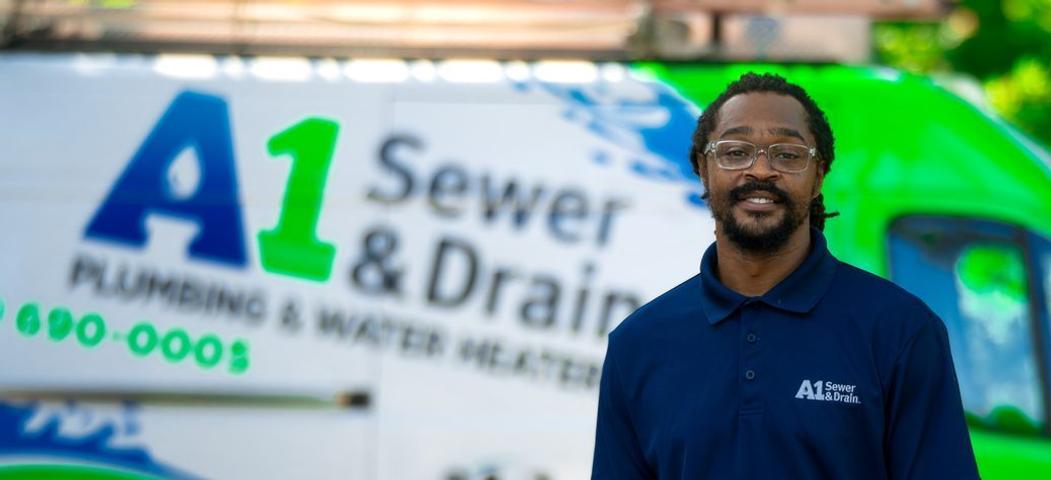 A1 technician with blurred van in the background, close up.