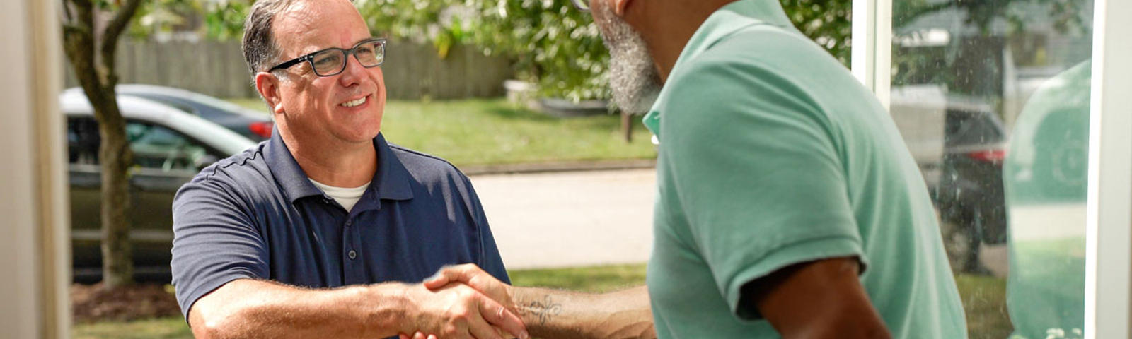 The technician and customer greeted each other with a handshake at the front door.