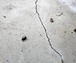Close up of a floor crack in a garage.