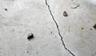 Close up of a floor crack in a garage.
