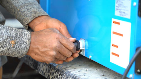 Groundworks production crew installing hose on dehumidifier
