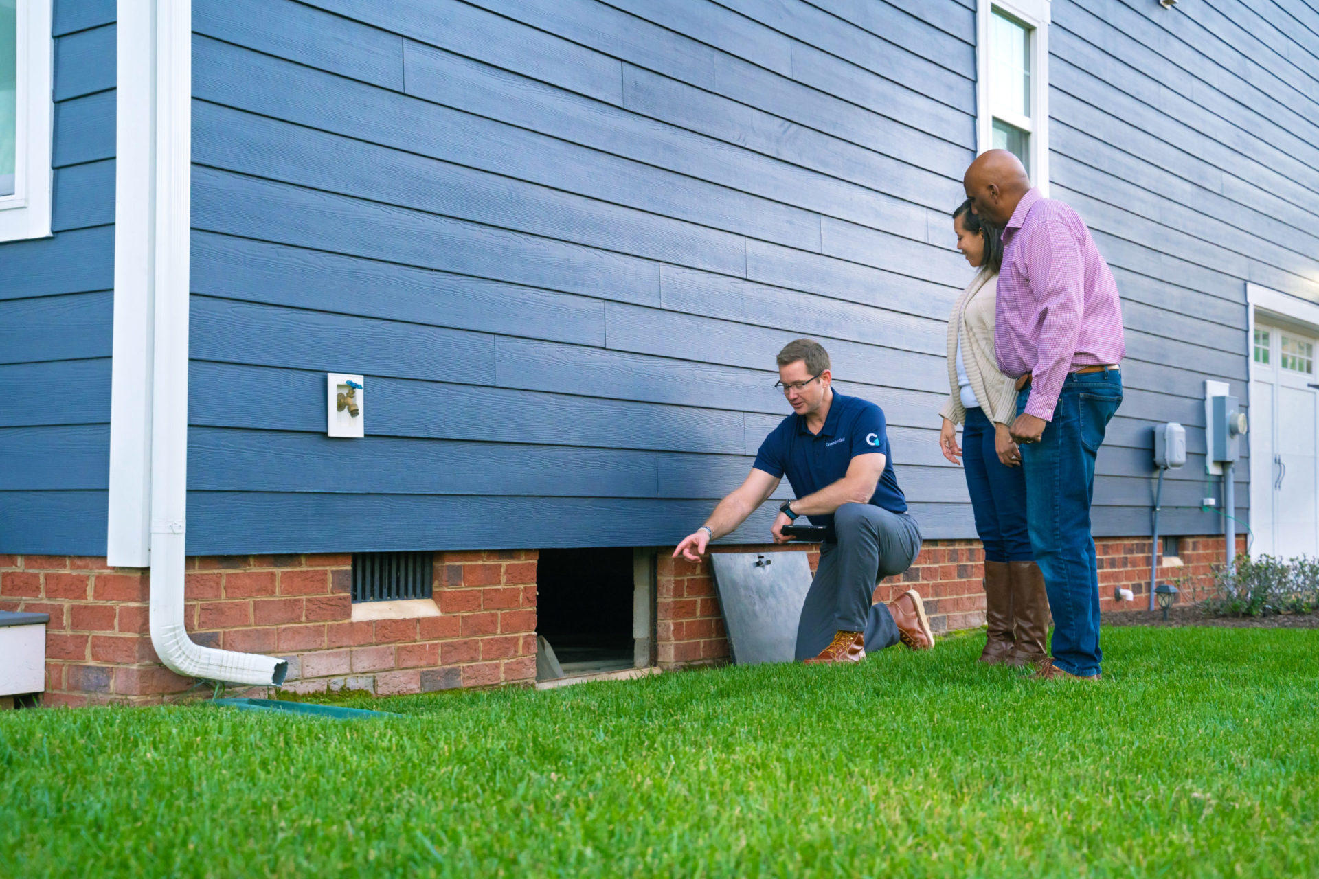 CFI showing crawlspace to couple outside the home.
