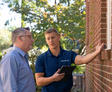 CFI and customer discussing the side of the home.