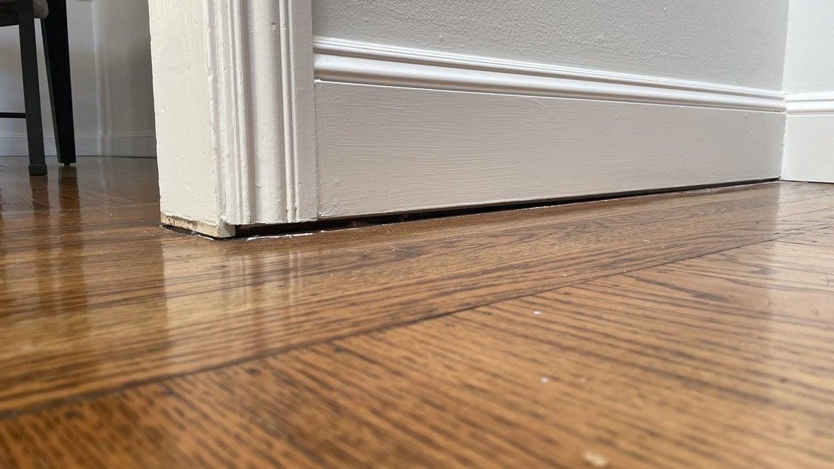 Close up of uneven and a bouncy floor in the interior of a home.