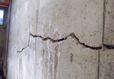 Close up of a crack in a bowing basement wall.
