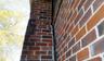 Exterior photo of a chimney separating on a brick home.