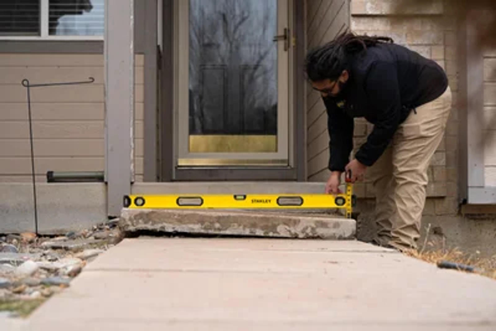 Groundworks Tech levels and repairs steps in front of home