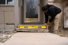 Groundworks Tech levels and repairs steps in front of home