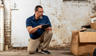 A Groundworks worker inspecting a basement.
