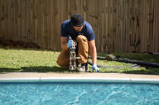 Groundworks tech repairing concrete on pool deck
