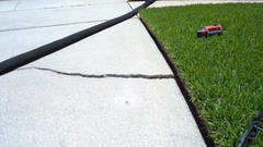 Closed up of a crack in a driveway.