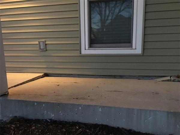 view of a home with lifting concrete porch