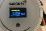 Close-up of a Radon Eye device displaying a radon gas level of 1109 Bq/m³ on its screen, emphasizing the urgent need for effective radon mitigation.