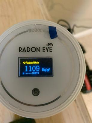 Close-up of a Radon Eye monitor displaying a reading of 110.9 Bq/m³, offering insights crucial for effective radon mitigation.