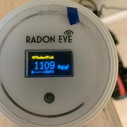 Close-up of a Radon Eye RD200 monitor displaying a reading of 1109 Bq/m³.