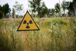 Radon warning sign in field