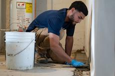 A Groundworks CFI waterproofing a basement.