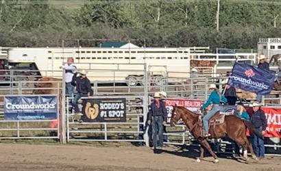 Man rides on horse with Groundworks flag