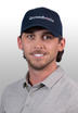 Smiling man in a grey polo shirt wearing a navy cap with "Groundworks" logo.