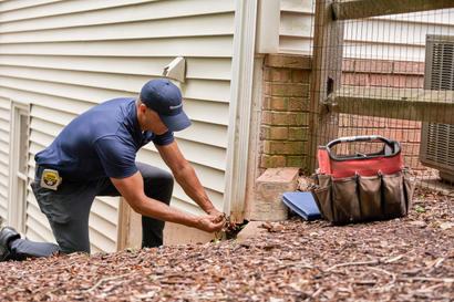 groundworks inspector looking at downspout