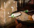 caulk gun with epoxy sealant on block basement wall