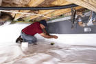 CFI installing vapor barrier in crawlspace.