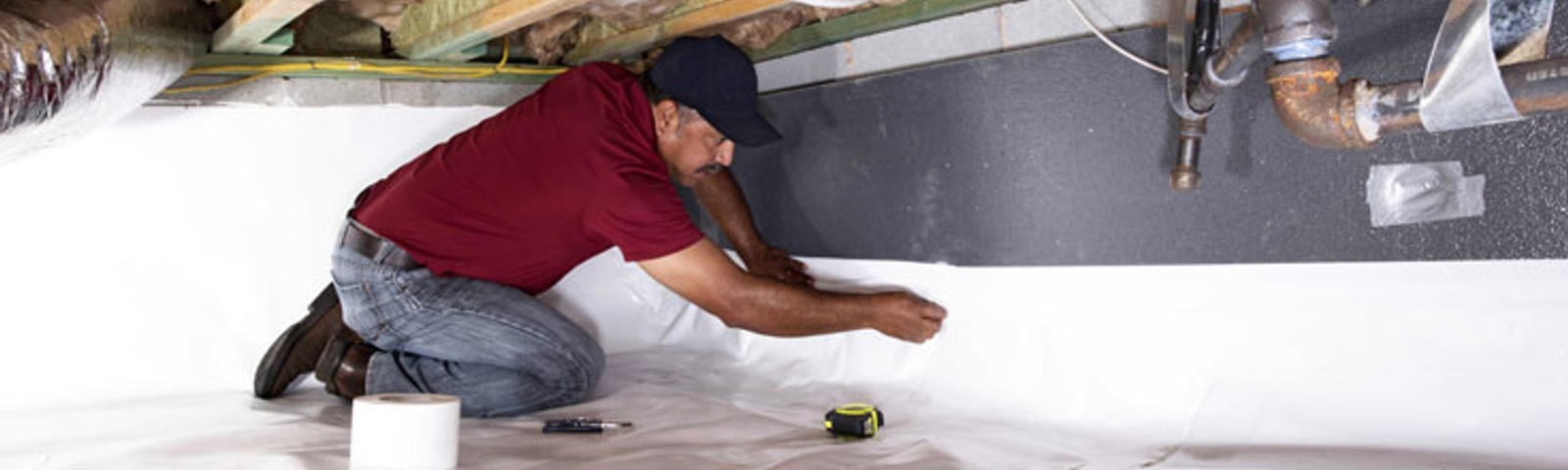 CFI installing vapor barrier in crawlspace.