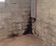 Water damage on the cinderblock basement wall.