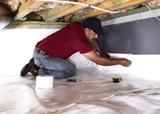 Crew member installing vapor barrier.