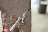 closeup of cracked concrete wall and dripping epoxy sealant