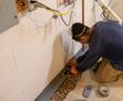 Crew installing drainage rocks around the interior drain.