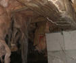 Dirty crawlspace with insulation falling.