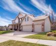two story house with small yard and driveway