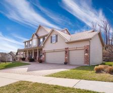 two story house with small yard and driveway