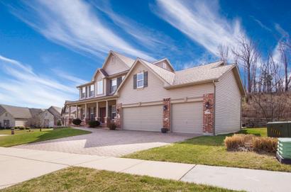 two story house with small yard and driveway