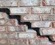 Gap and crack on an exterior brick wall.