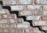 Gap and crack on an exterior brick wall.