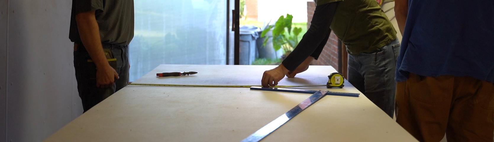 Crew measuring on table