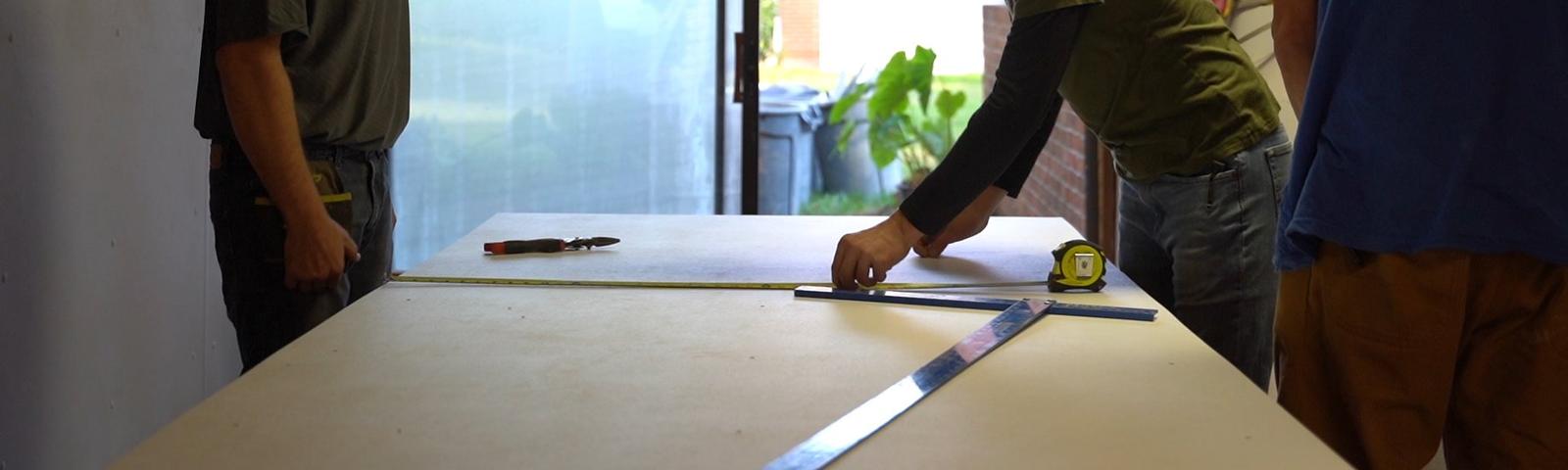 Crew measuring on table