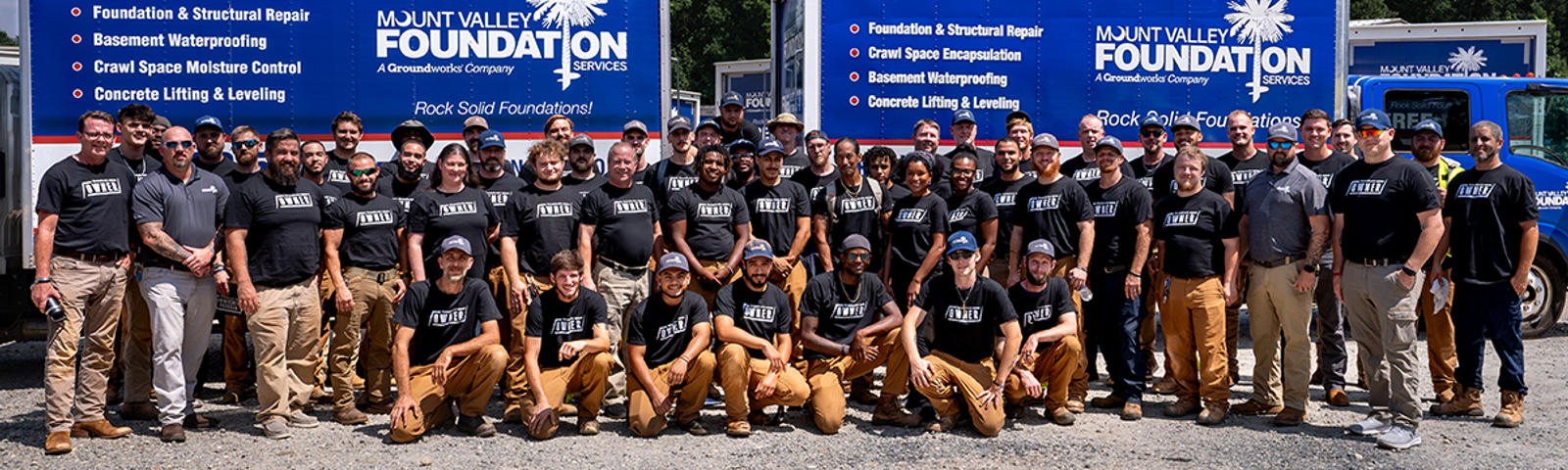 MVFS staff at Ownership Tour with supply trucks in the background.